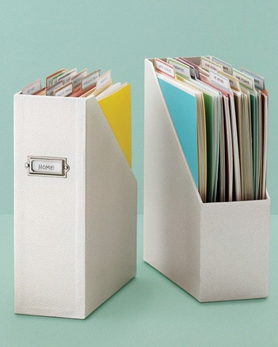 Well organised tidy paperwork in white vertical magazine files with a pale green background